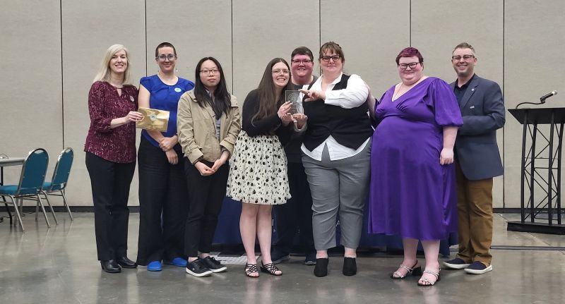A group of people holding an award.